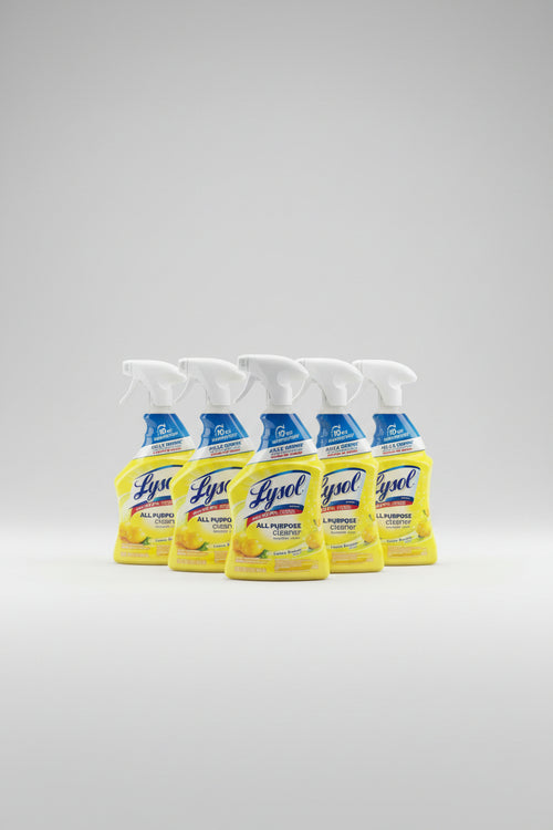 Three Lysol All Purpose Cleaner spray bottles in lemon scent arranged on a white shelf, with a large bottle of Lysol Multi-Problem Cleaner and Lemon Breeze also visible on the right.